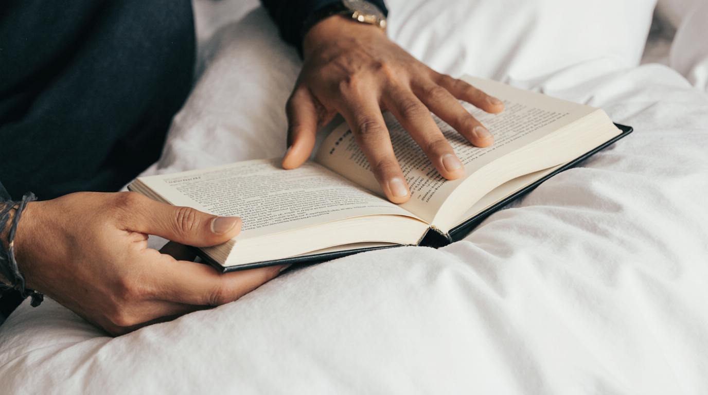 Reaching for a dream journal on the pillow in the first moments after waking